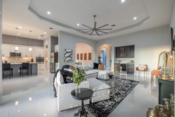 a kitchen with stainless steel appliances kitchen island granite countertop a table chairs and a refrigerator