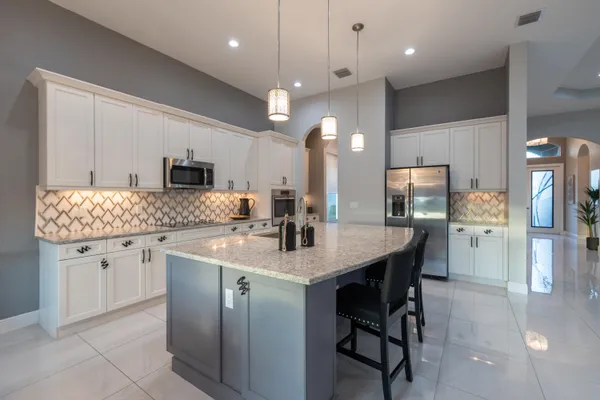 a view of empty room with wooden floor and ceiling fan