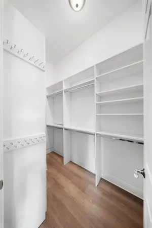 a front view of a house with a yard and palm trees