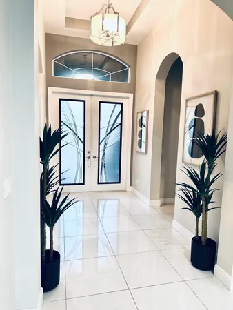 a view of a dining room with furniture and chandelier
