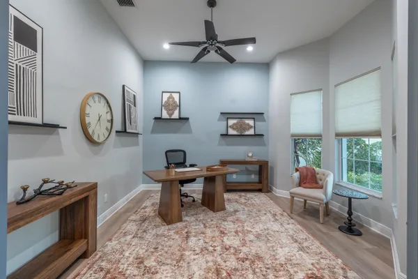 a view of a dining room with furniture and chandelier
