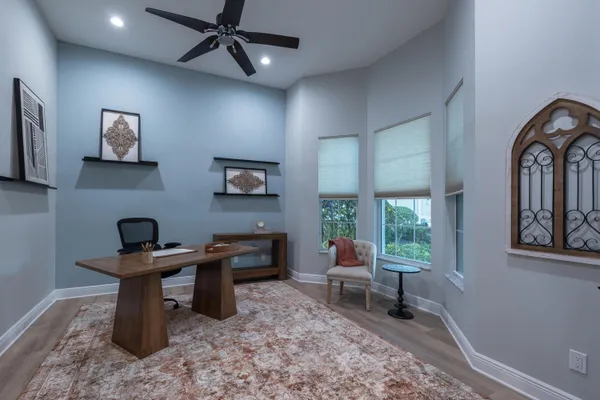 a living room with furniture a flat screen tv and a chandelier