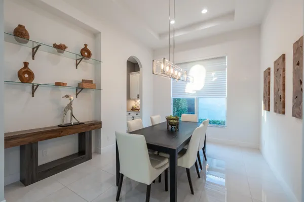a living room with furniture a flat screen tv and a large window