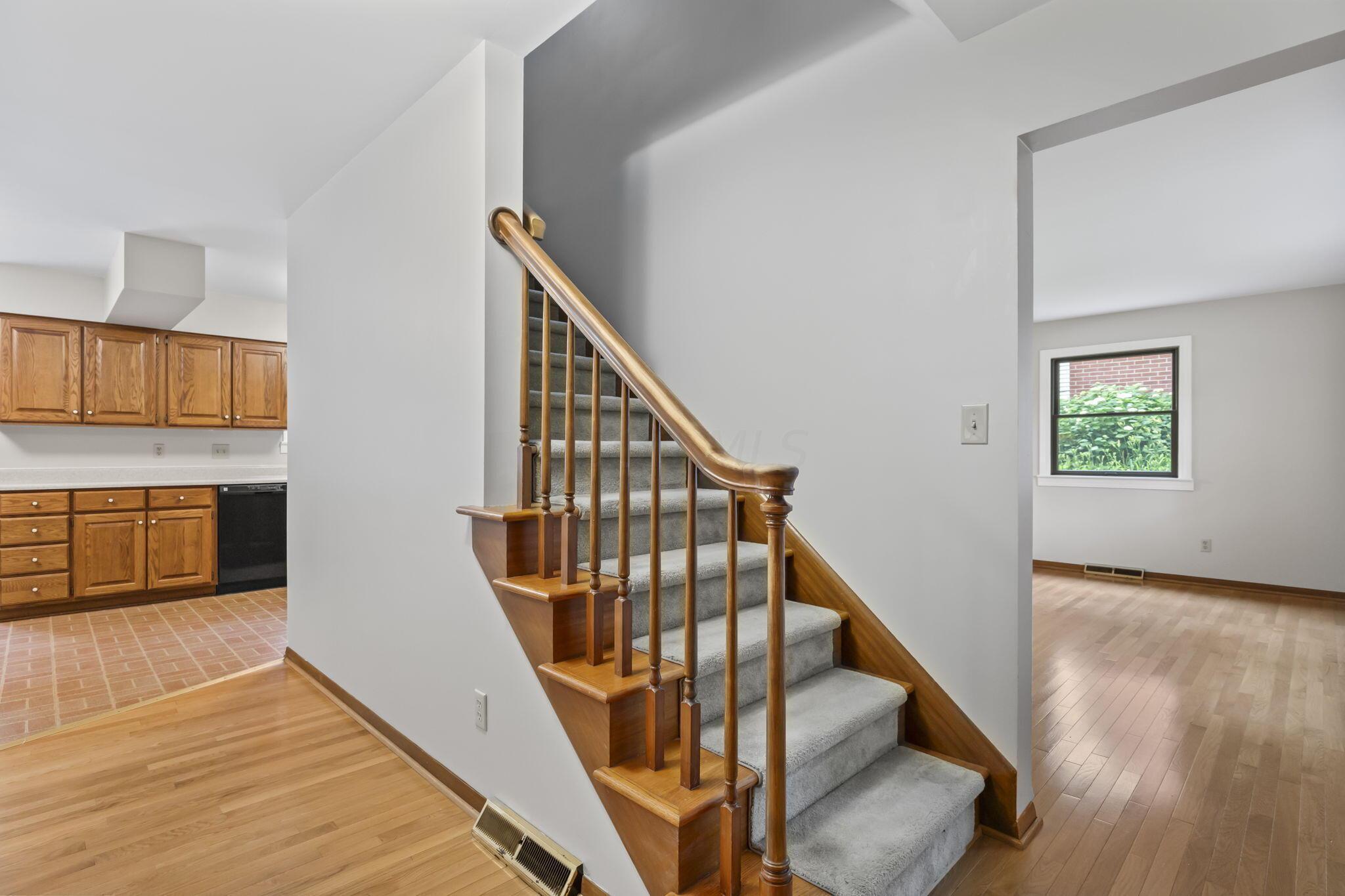 999 Birchmont Road Columbus, OH 43220 - Photo 9 of 53 Stairwell with wooden hand rails and fresh paint throughout this home.