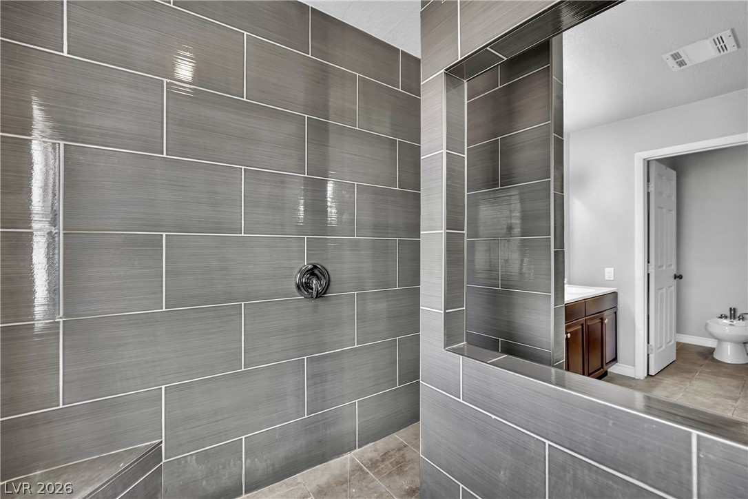 420 North Racetrack Road Henderson, NV 89015 - Photo 11 of 52 A well-appointed shower space, complete with sleek gray tile work and a convenient built-in niche.