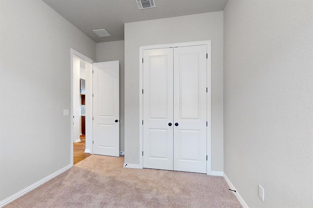 4907 Escape Rivera Drive Austin, TX 78747 - Photo 12 of 28 A well-proportioned room with plush carpeting offers versatile living options.