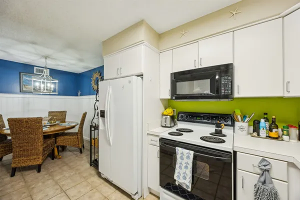 a kitchen with stainless steel appliances a stove a sink and a refrigerator