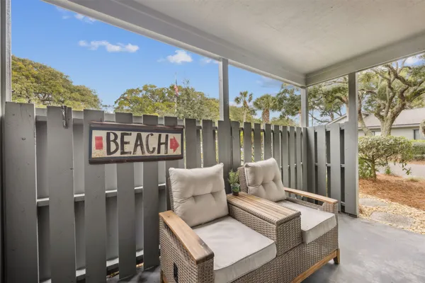 a view of a terrace with couches and wooden floor