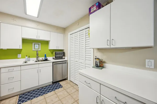 a kitchen with sink cabinets and window
