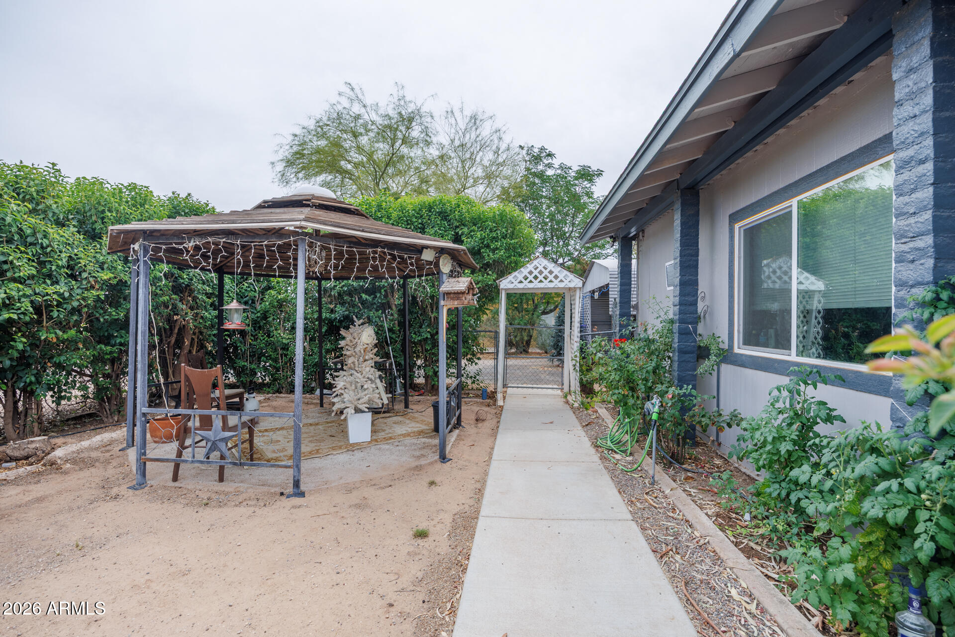 6185 East Monitor Street Picacho, AZ 85141 - Photo 3 of 55 a patio with a table and chairs under an umbrella