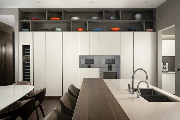 a kitchen with a sink a refrigerator and cabinets