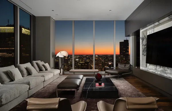 a living room with furniture a flat screen tv and a floor to ceiling window