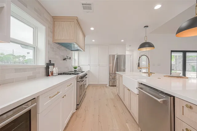 a kitchen with a sink cabinets and window