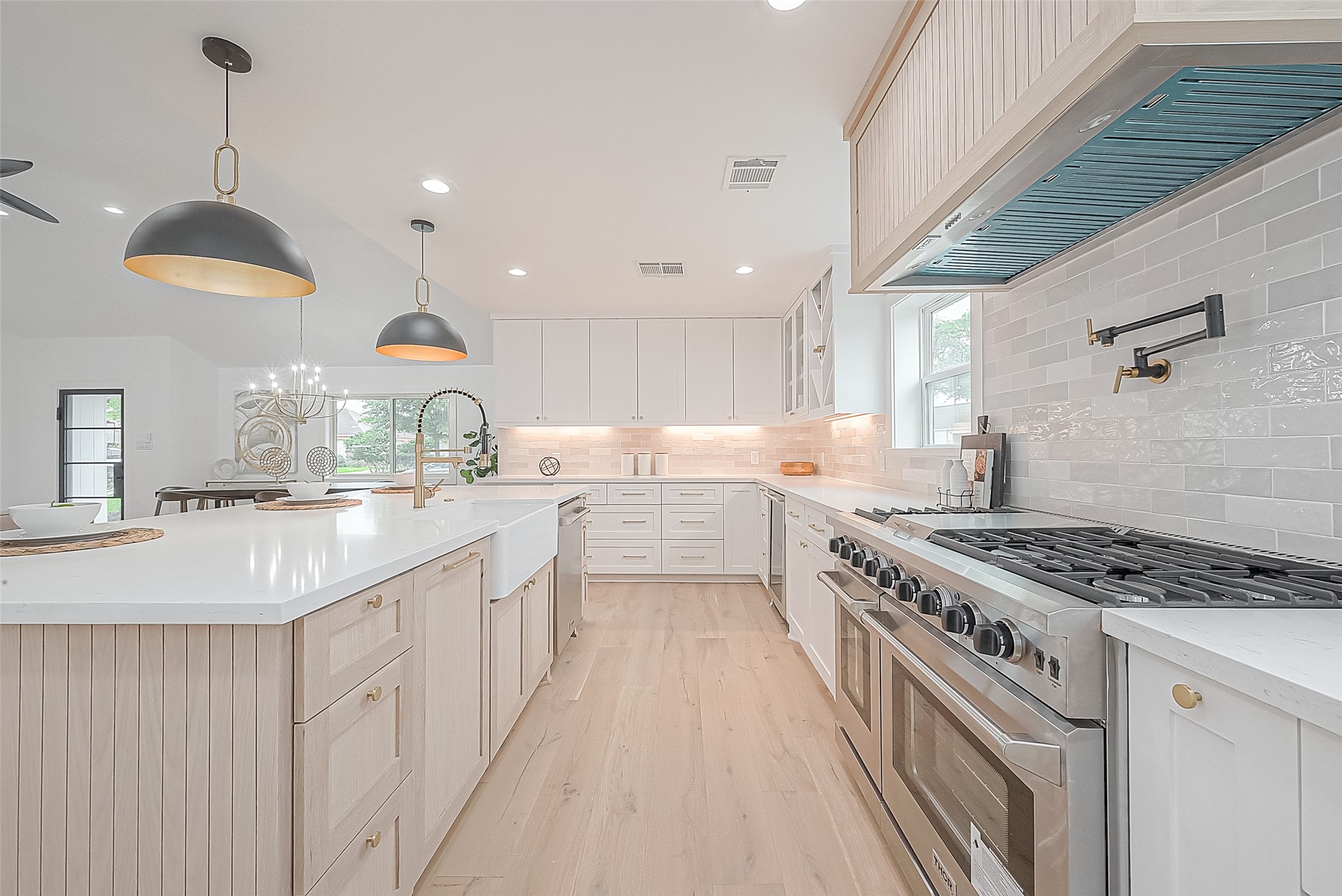 6254 Locke Lane Houston, TX 77057 - Photo 14 of 44 a kitchen with stainless steel appliances granite countertop a sink a stove and a wooden floors