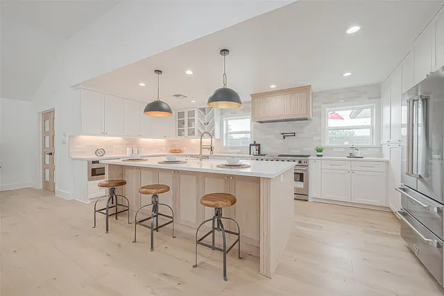 a living room with furniture a dining table and a large window