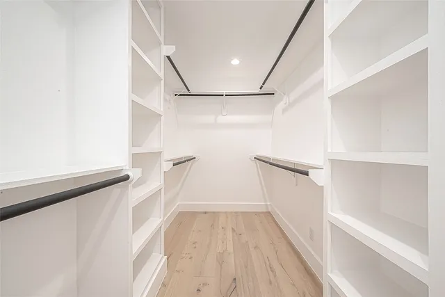 a bathroom with a sink a toilet a mirror and shower