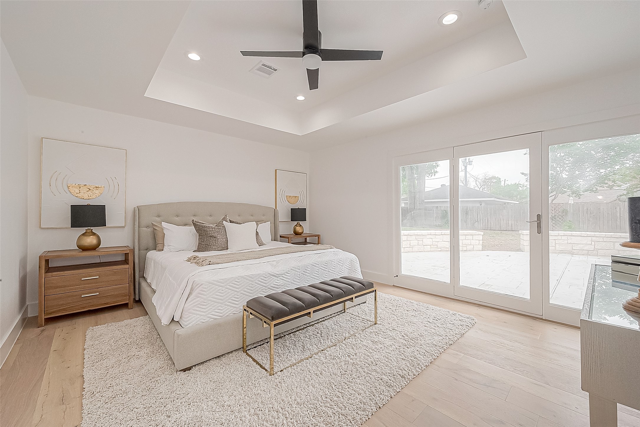 6254 Locke Lane Houston, TX 77057 - Photo 24 of 44 a spacious bedroom with a large bed and a chandelier