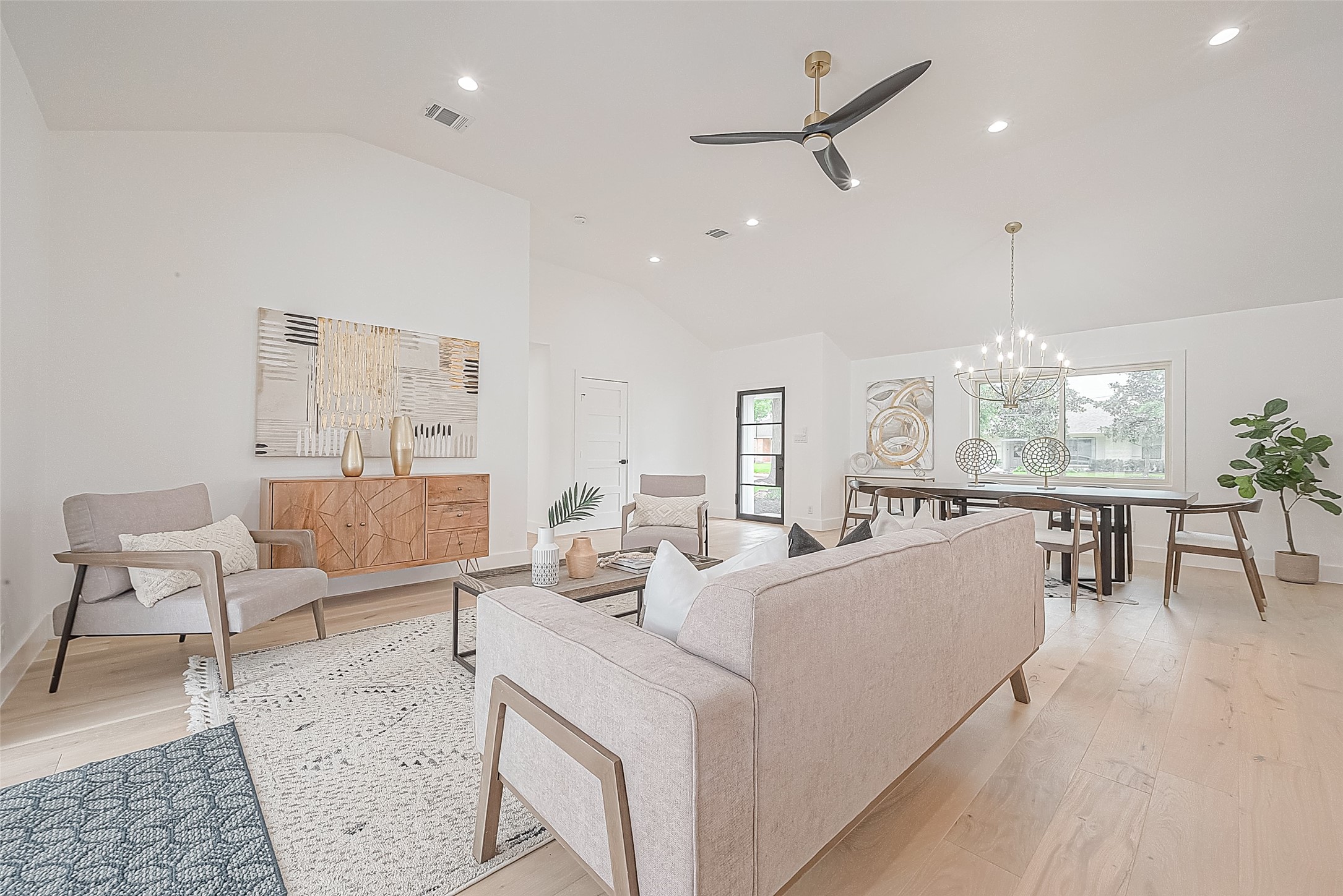 6254 Locke Lane Houston, TX 77057 - Photo 26 of 44 a living room with furniture a dining table and a large window