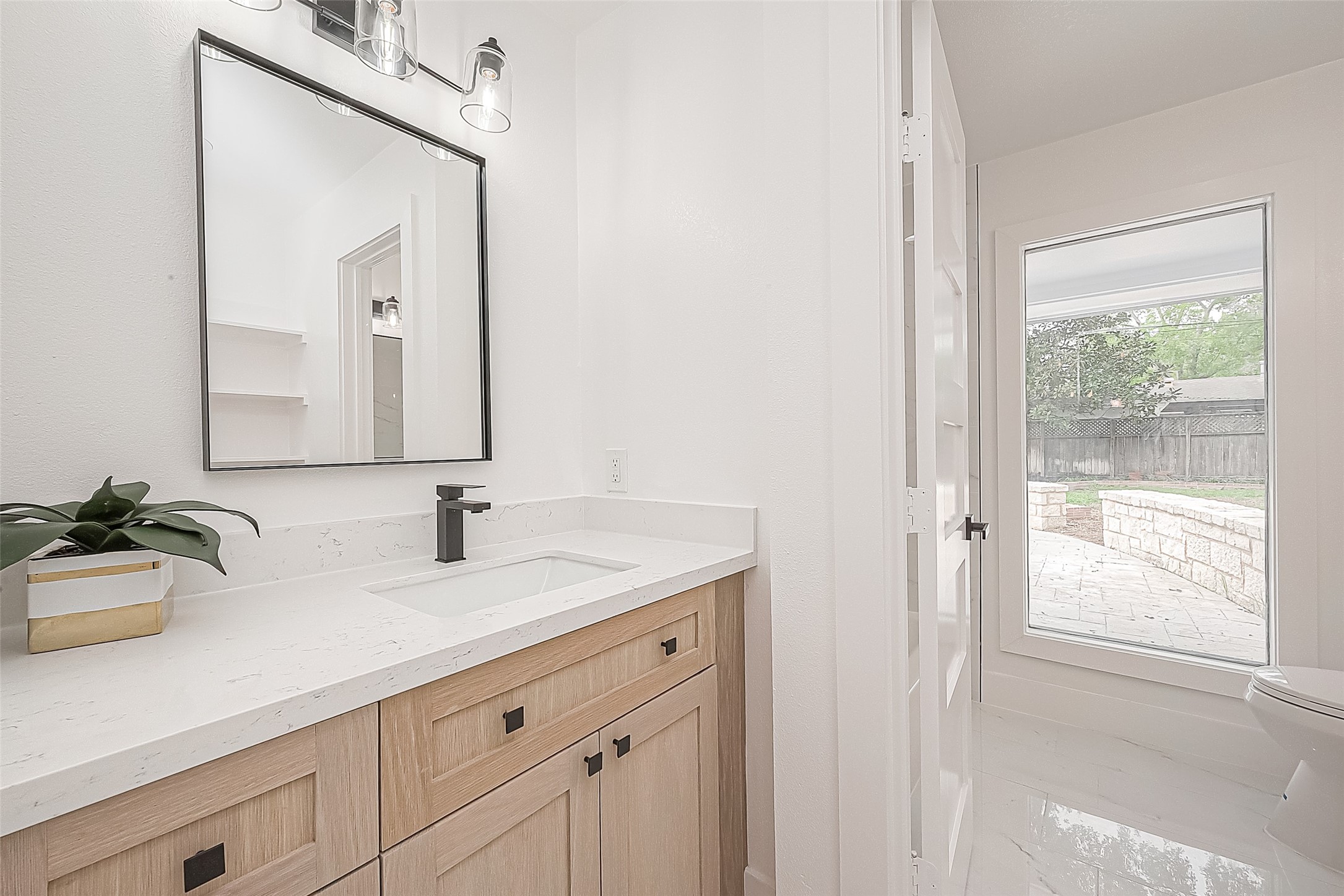 6254 Locke Lane Houston, TX 77057 - Photo 28 of 44 a bathroom with a sink and a mirror