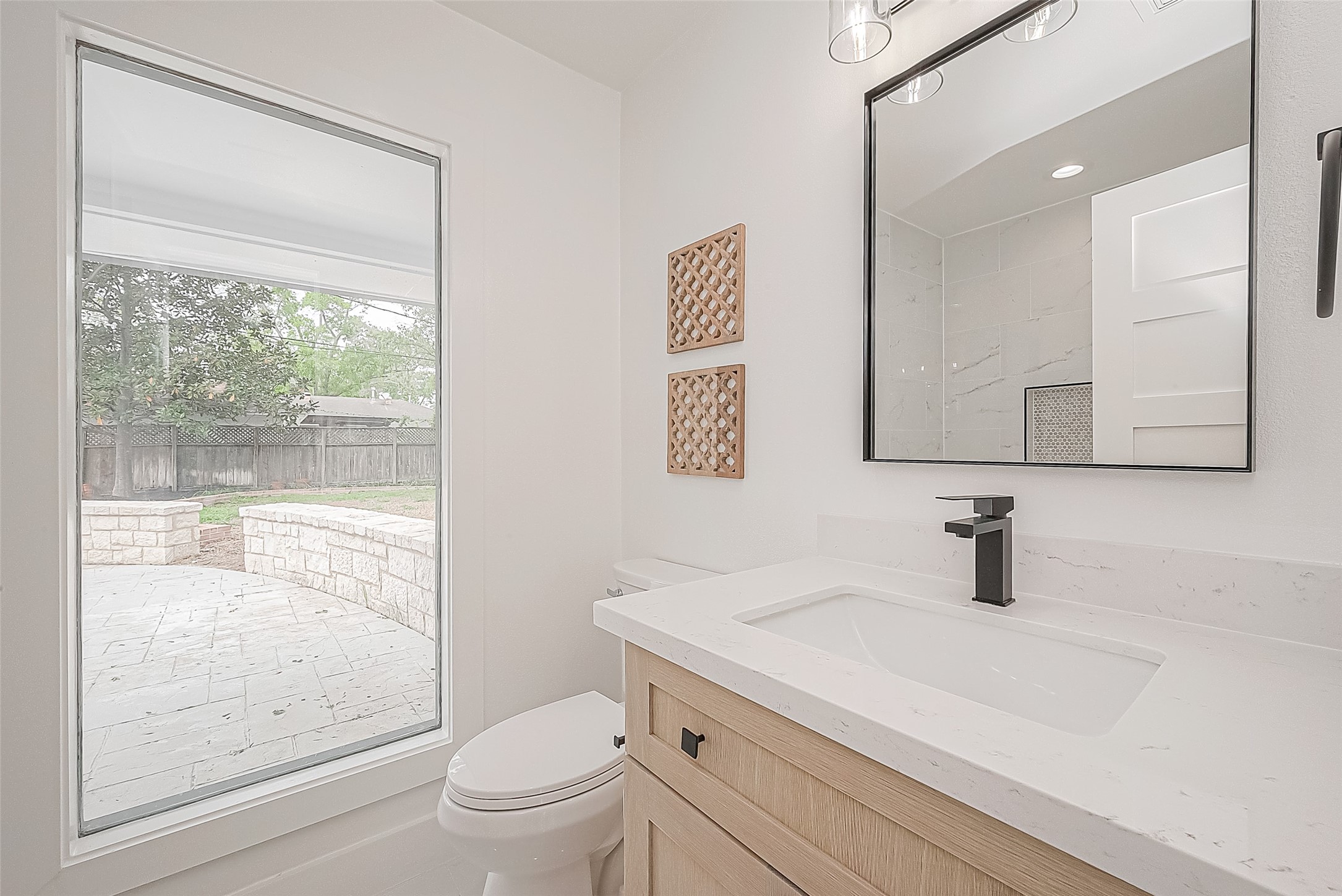 6254 Locke Lane Houston, TX 77057 - Photo 29 of 44 a bathroom with a sink a toilet a mirror and shower