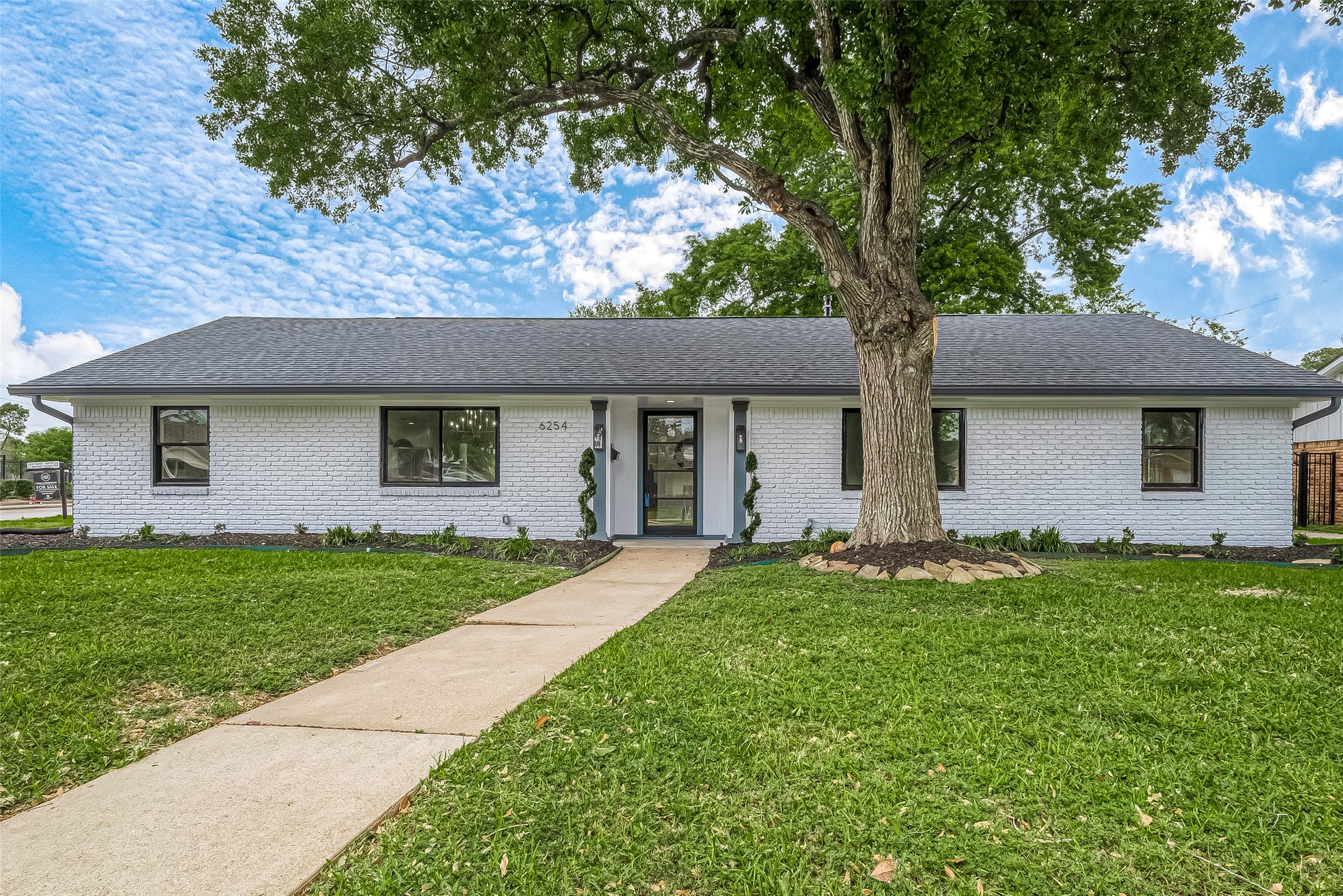 6254 Locke Lane Houston, TX 77057 - Photo 44 of 44 a front view of a house with a garden