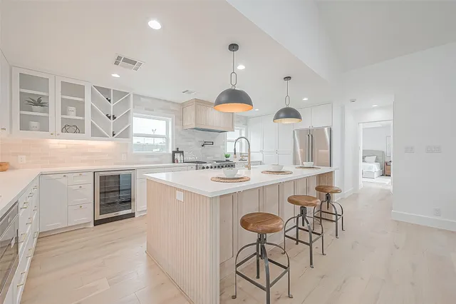 a kitchen with a sink stove and cabinets