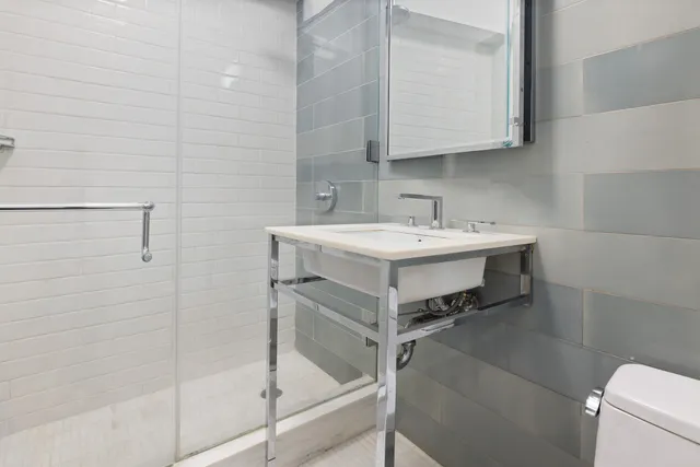 a kitchen with granite countertop cabinets stainless steel appliances and a counter space