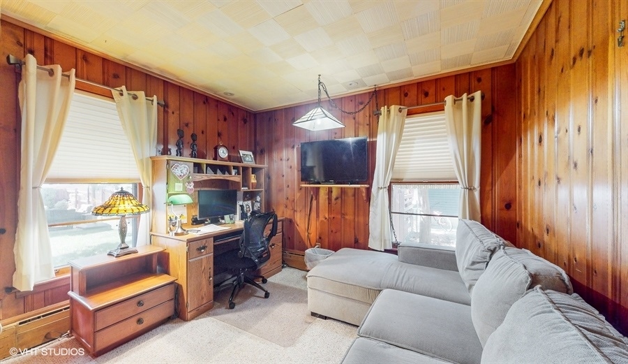 633 Oakland Avenue Elgin, IL 60120 - Photo 13 of 35 a living room with furniture a lamp and a window