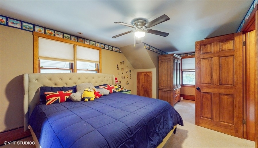 633 Oakland Avenue Elgin, IL 60120 - Photo 18 of 35 a bedroom with a bed and a chandelier