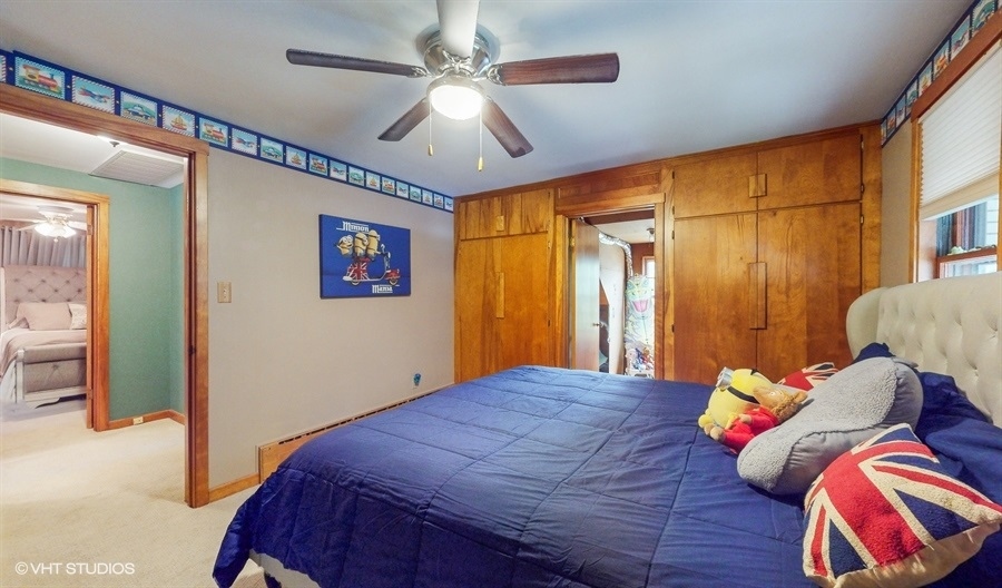 633 Oakland Avenue Elgin, IL 60120 - Photo 19 of 35 a bed room with a bed and a painting on the wall