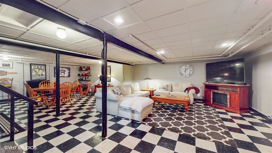 633 Oakland Avenue Elgin, IL 60120 - Photo 22 of 35 a bedroom with furniture and a flat screen tv