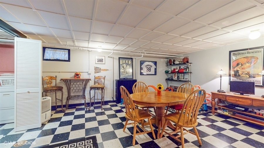 633 Oakland Avenue Elgin, IL 60120 - Photo 24 of 35 a living room with furniture and a dining table with wooden floor