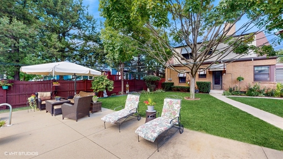 633 Oakland Avenue Elgin, IL 60120 - Photo 30 of 35 a view of a house with backyard sitting area and garden