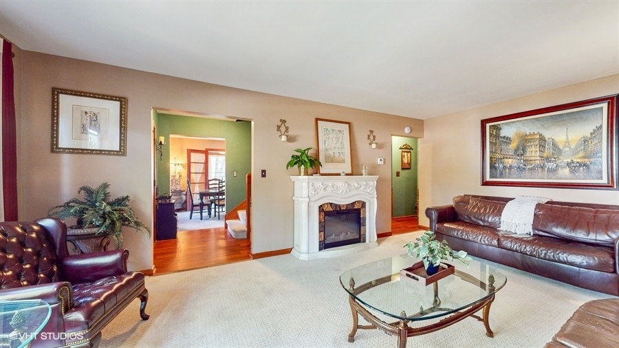 633 Oakland Avenue Elgin, IL 60120 - Photo 3 of 35 a living room with furniture a dining table and a fireplace
