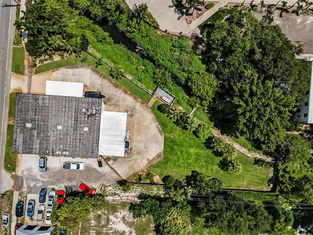 an aerial view of residential house with outdoor space and trees