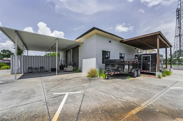 a view of a house with a patio and a yard