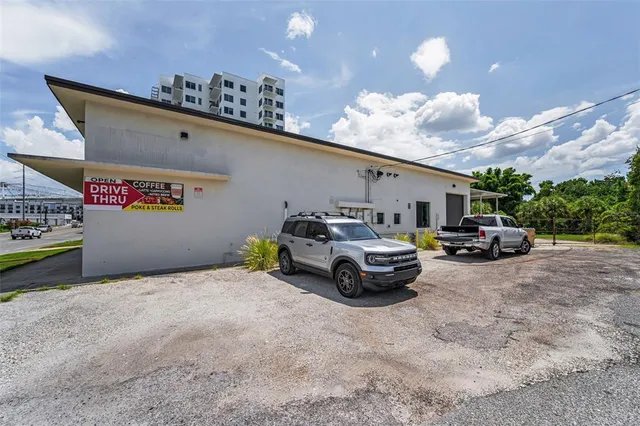 a view of a cars park in front of a building
