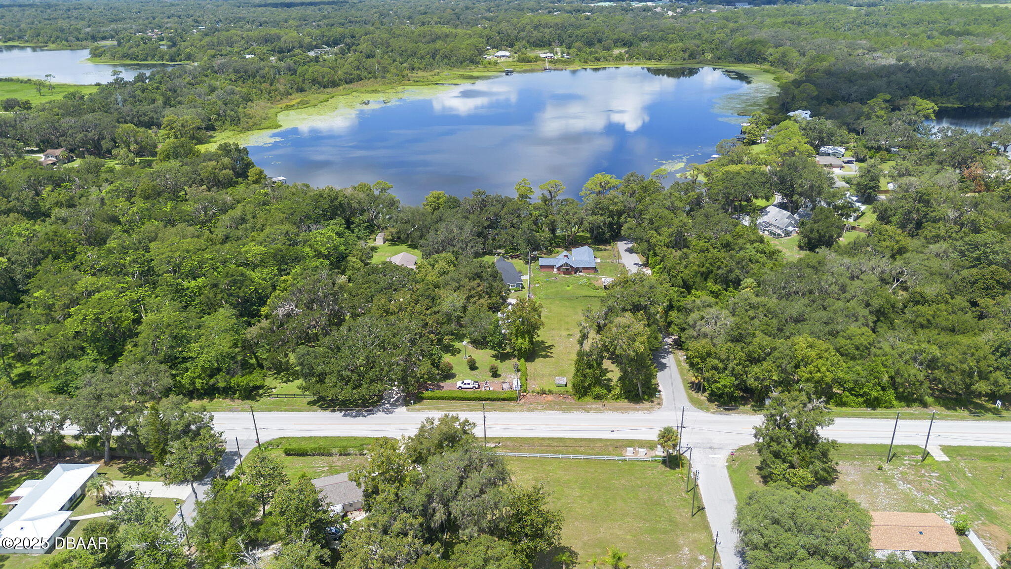 2202 Lake Ruby Road DeLand, FL 32724 - Photo 11 of 13 an aerial view of residential houses with outdoor space and trees all around