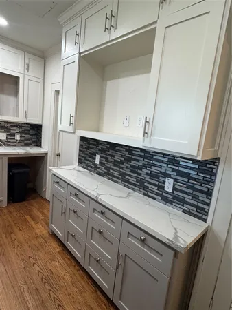 a kitchen with granite countertop a sink and a stove top oven