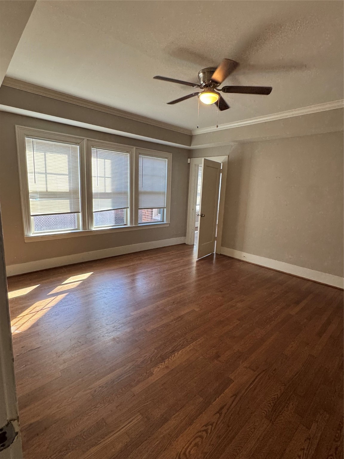 2307 Arbor Street, Unit 1 Houston, TX 77004 - Photo 5 of 11 a view of an empty room with wooden floor and a window