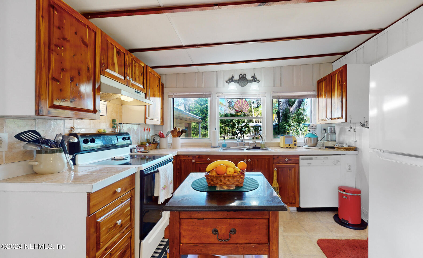 134 East End Road San Mateo, FL 32187 - Photo 19 of 45 a kitchen with stainless steel appliances granite countertop a sink stove and refrigerator