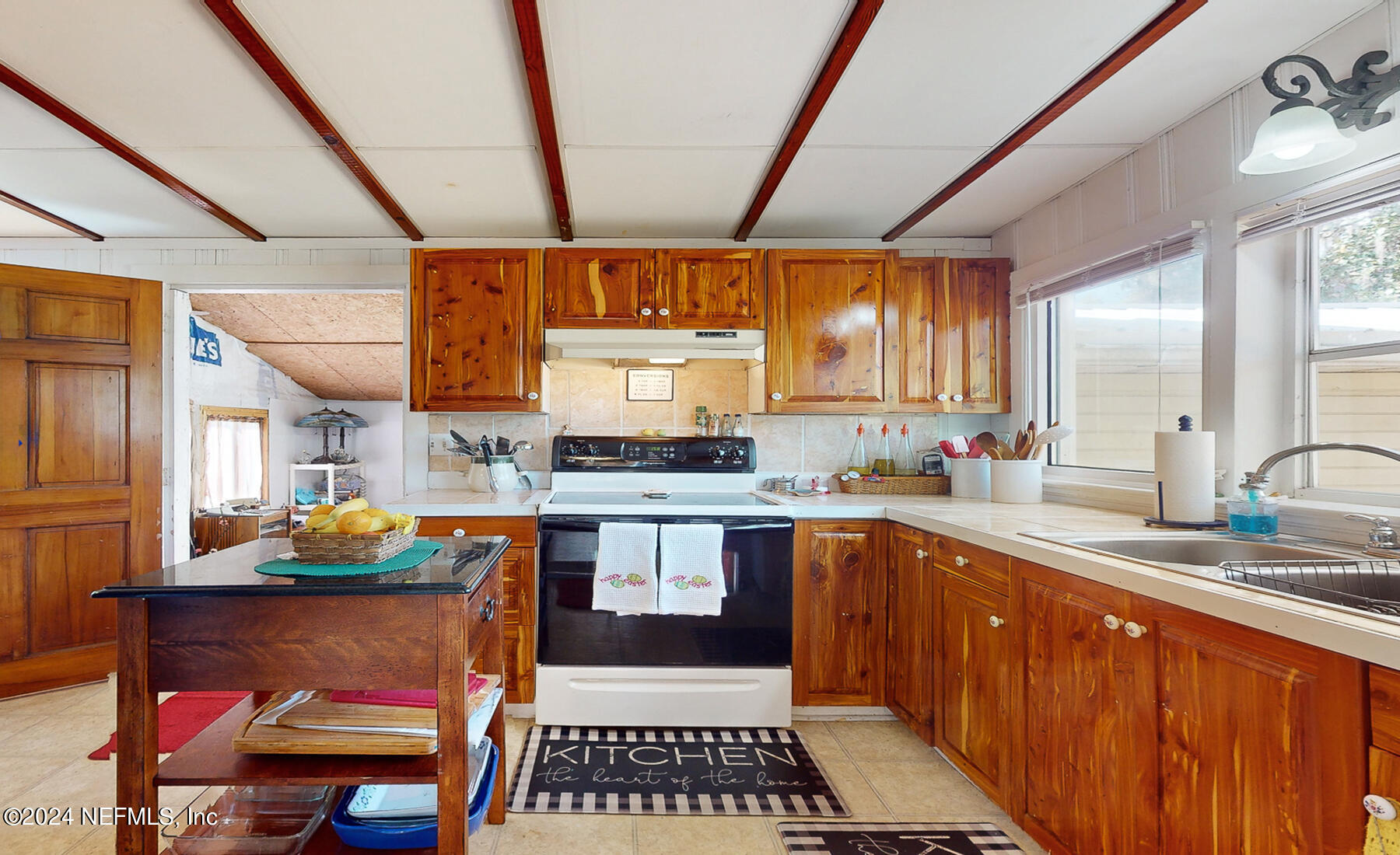 134 East End Road San Mateo, FL 32187 - Photo 21 of 45 a kitchen with stainless steel appliances granite countertop a sink and wooden cabinets