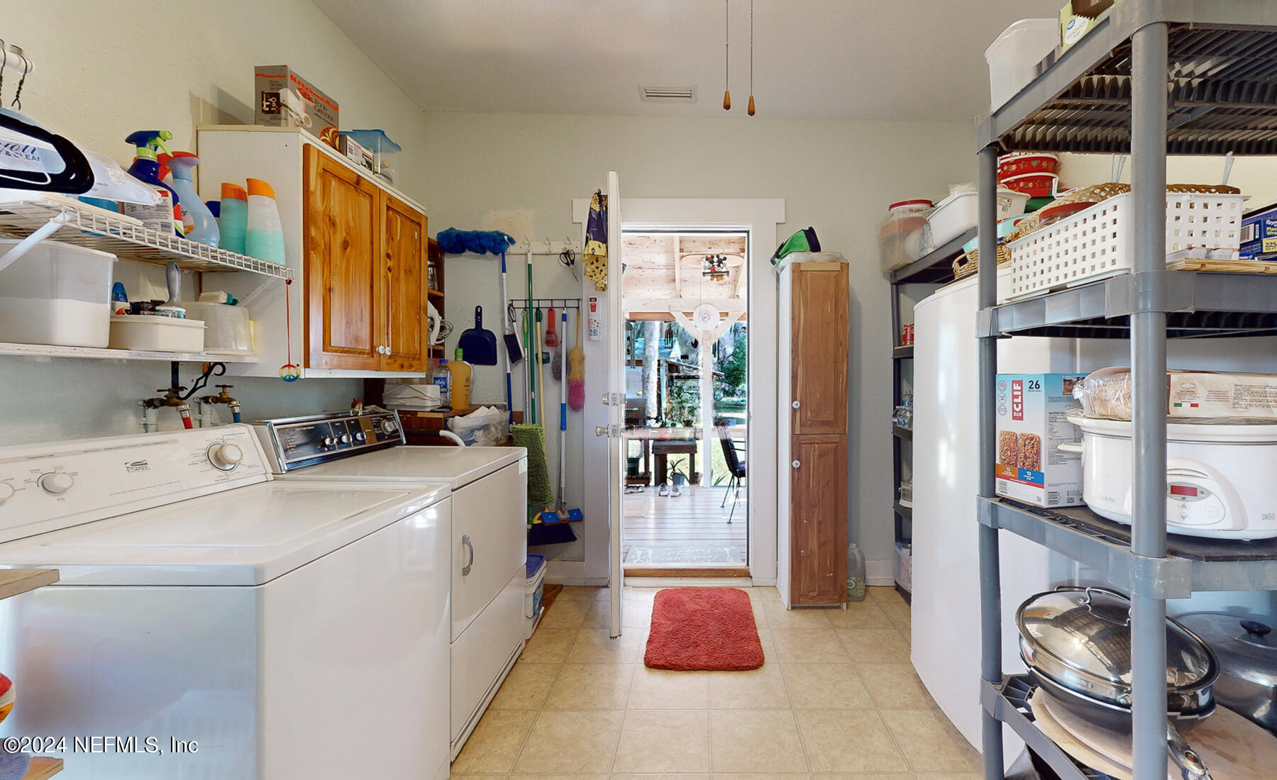 134 East End Road San Mateo, FL 32187 - Photo 22 of 45 a kitchen that has a lot of cabinets a sink and a refrigerator in it