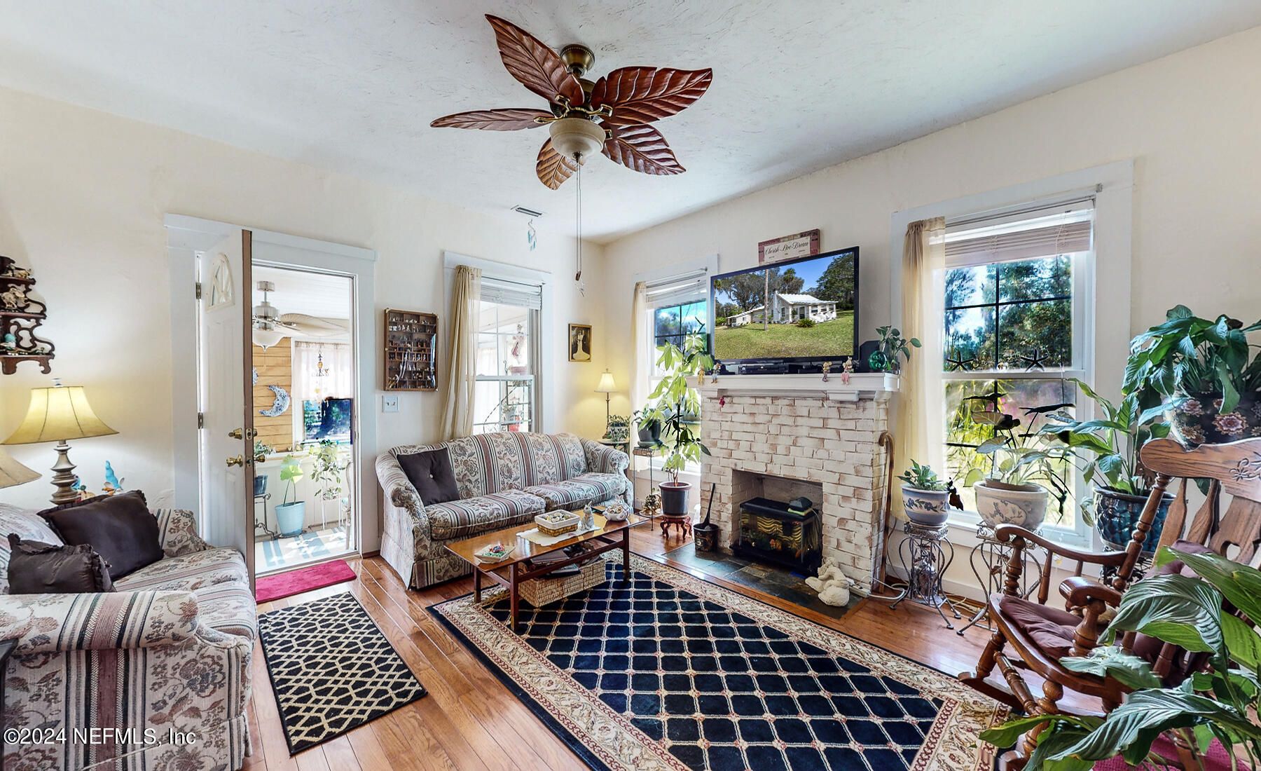 134 East End Road San Mateo, FL 32187 - Photo 5 of 45 a living room with furniture a flat screen tv and a fireplace