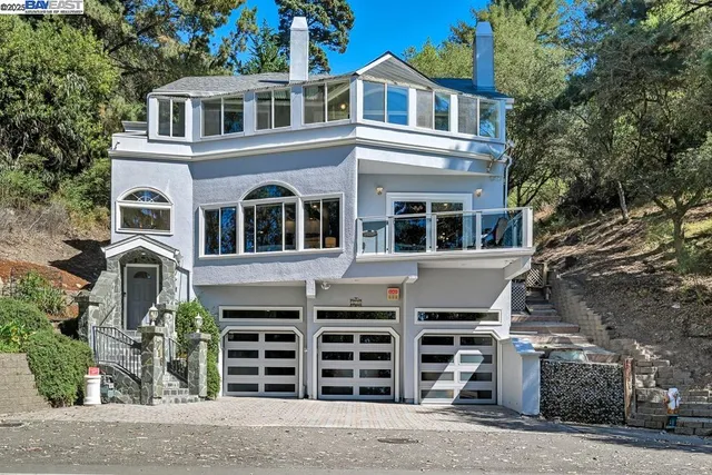 a front view of a house with a road