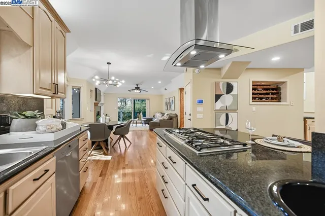 a kitchen with stainless steel appliances granite countertop a sink stove and refrigerator