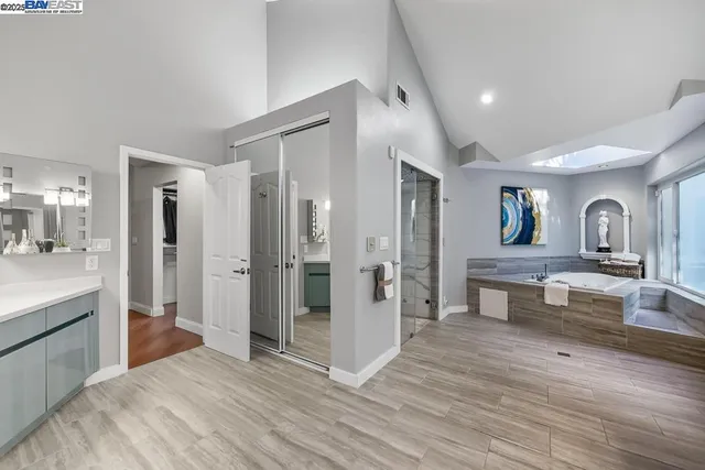 a spacious bathroom with a granite countertop sink a toilet and shower