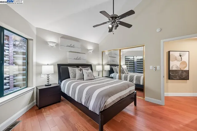 a bathroom with a granite countertop sink a large mirror and shower