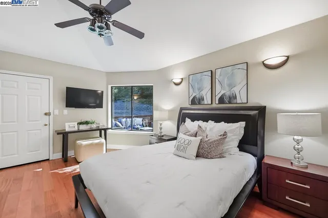 a bedroom with a large bed and a window