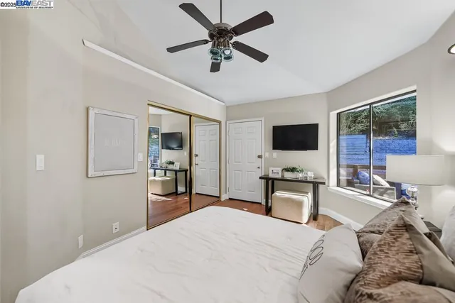 a bedroom with a large bed and a large window